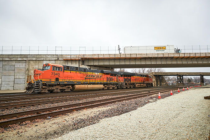 Construction underway at the Cicero Intermodal Facility, with BNSF locomotives on the track below a bridge as a J.B. Hunt truck drives by. Construction underway at the Cicero Intermodal Facility, with BNSF locomotives on the track below a bridge as a J.B. Hunt truck drives by.