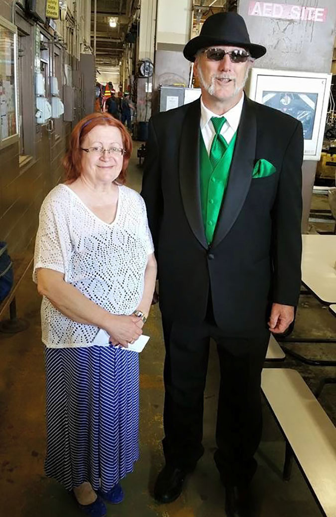 Mark and his wife at his retirement party. “It was common for most men to wear a suit on their final day,” he said of his BN green accessories. Mark and his wife at his retirement party. “It was common for most men to wear a suit on their final day,” he said of his BN green accessories.